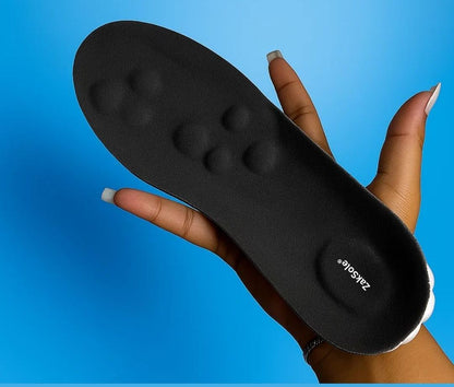 Black shoe insole held by a hand against a blue background